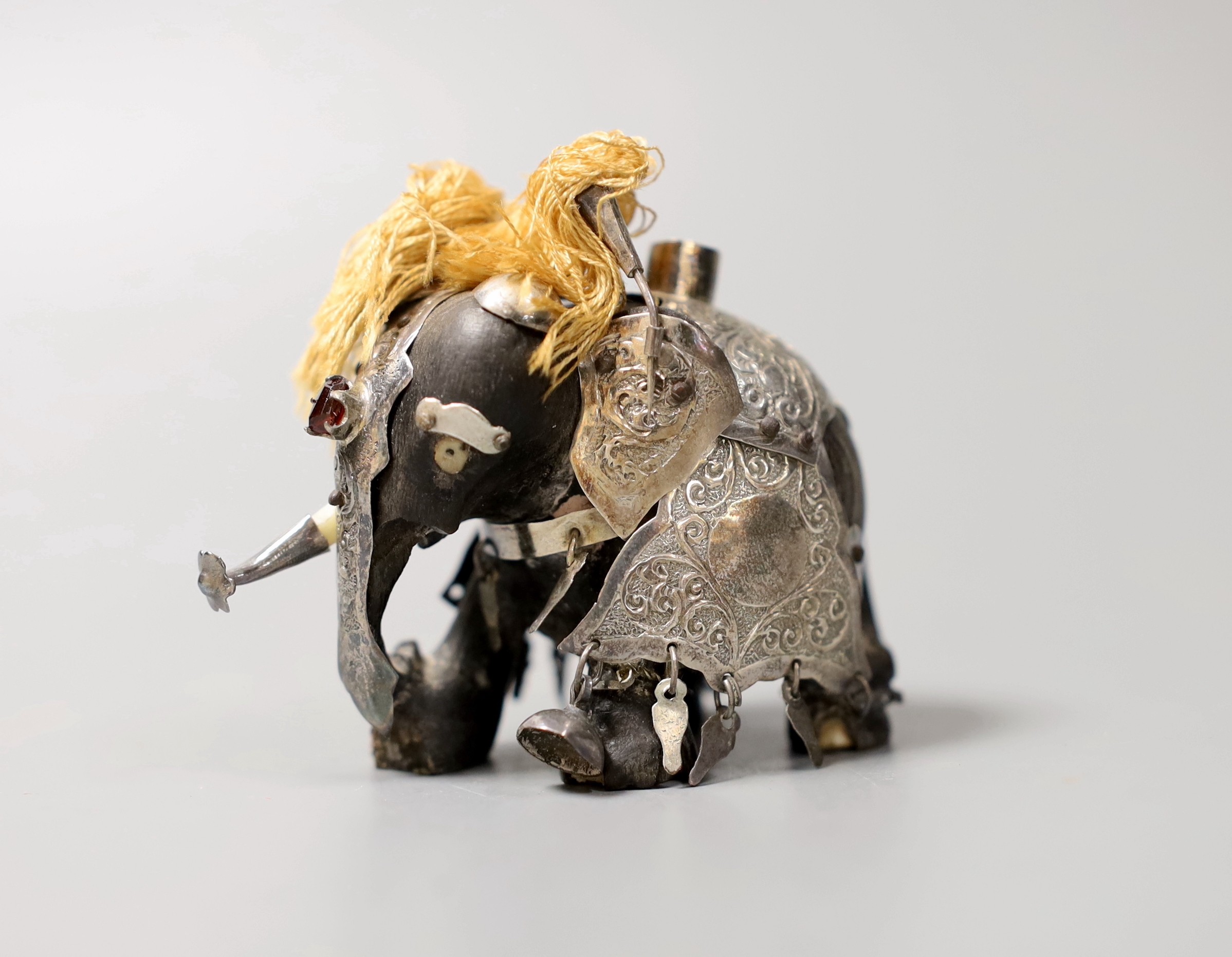 Sundry small silver including a late Victorian silver mounted pepper grinder, a paired silver vase, two handle trophy cup and a cigarette case, together with a white metal mounted miniature elephant with howdah and three